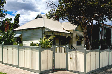 Picket and handrtail fence with inset wooden gate